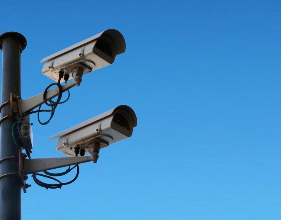 Surveillance cameras against blue sky