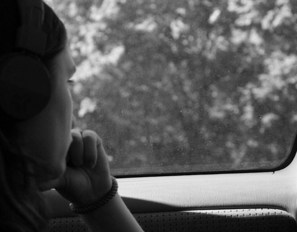 grayscale photo of woman inside car