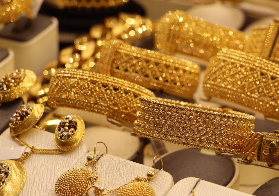 a bunch of gold jewelry on display in a store