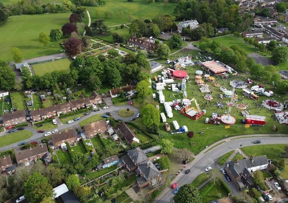 Aerial shot of a fairground amidst homes in Houghton Regis, England.