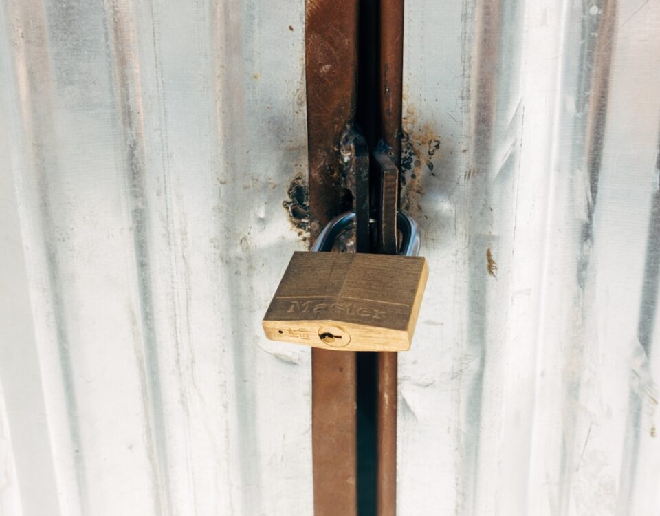 brown wooden cross with padlock