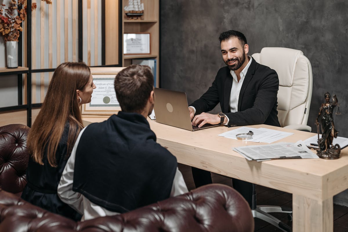 A professional meeting with a lawyer consulting clients in an upscale office environment.